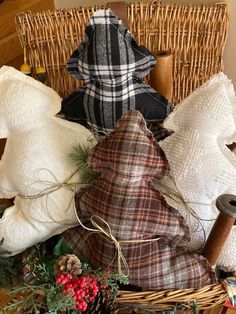 a wicker basket filled with white and brown pillows next to a christmas tree ornament