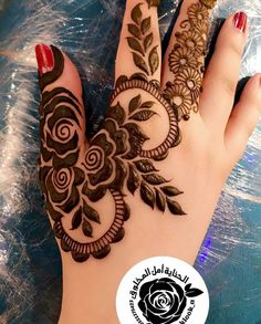 hendi design on the palm of a woman's hand with flowers and leaves