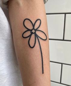 a woman's arm with a tattoo on it that has a black bow in the middle