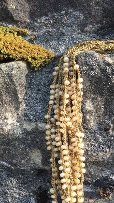 necklace crocheted with white seed beads and ocre thread Bohemian Handwoven White Beads, Bohemian Beaded Necklaces With Crochet For Beach, Handmade White Lariat Pearl Necklace, Handmade White Pearl Lariat Necklace, Bohemian Beaded Crochet Necklaces For Beach, Bohemian Crochet Beaded Necklaces For The Beach, White Crochet Bohemian Necklace, Bohemian White Crochet Necklace, Cream Beaded Necklaces For Beach