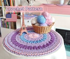 a crochet pattern with the eiffel tower in the background and yarn balls on top