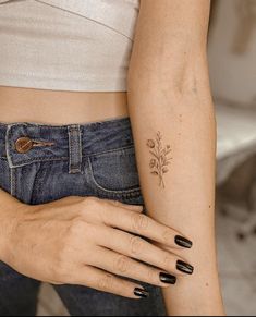 a woman's arm with a flower tattoo on the left side of her body