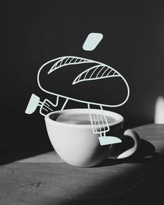 a black and white photo of a coffee cup