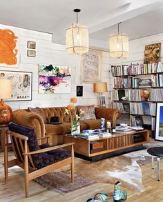 a living room filled with furniture and lots of books