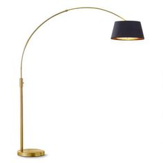 a floor lamp with a black shade on the base and a gold colored metal arm