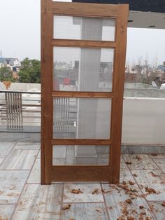 an open wooden door on top of a roof