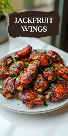 a white plate topped with chicken wings covered in sauce