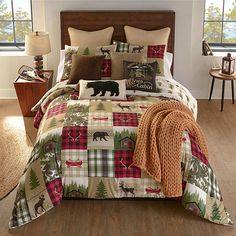 a bed in a bedroom with plaid comforter and pillows