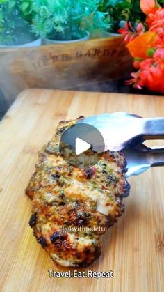 a piece of food sitting on top of a wooden cutting board next to a knife