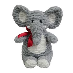 an elephant stuffed animal with a red ribbon around its neck