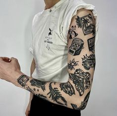 a man with tattoos on his arm holding a cell phone