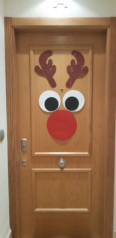 a door decorated with a reindeer's face and nose