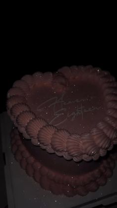 there is a chocolate cake with writing on the frosting and stars in the background