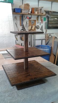 three tiered wooden shelf with tools on it