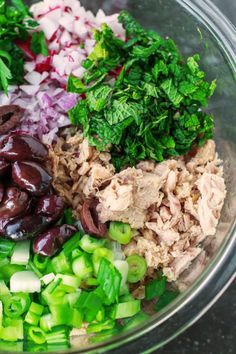 the ingredients for this salad are mixed together in a large bowl, including onions, celery, and olives