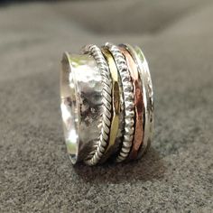 "Benefits Of Spinner Ring ---------------------------------------------- A spinner ring is a ring that you wear on your finger, usually silver, that has an inner band locked in place that can be spun while the rest of the ring stays in one place on your finger. The spinner ring is believed to come from ancient Tibetan meditation traditions, and is called a \"worry ring\" because spinning the right is believed to have a calming effect on the mind and body. While some spinner ring supporters argue Tibetan Meditation, Thea Queen, Friendship Ring, Worry Ring, Friendship Rings, Meditation Rings, Spinner Ring, Spinner Rings, Fidget Spinner