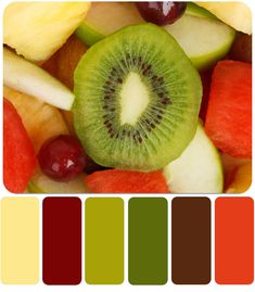 a bunch of fruit with different colors in the middle, including kiwi and grapes