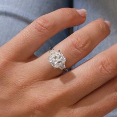 a woman's hand with a diamond ring on it