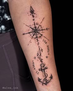 a man's arm with an anchor and compass tattoo on the left side of his arm