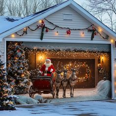 santa claus riding in his sleigh with reindeers and christmas lights on the garage door