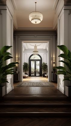 an elegant entry way with potted plants on either side