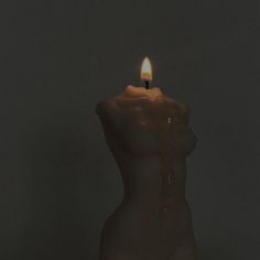 a candle that is lit up in the dark with no light on it and only one candle