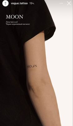 a person with a tattoo on their arm and the word moon written in black ink