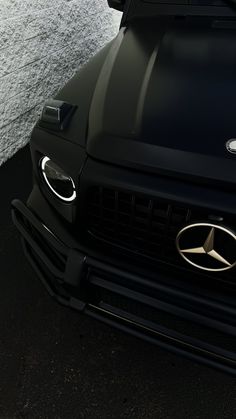 the front end of a black mercedes car