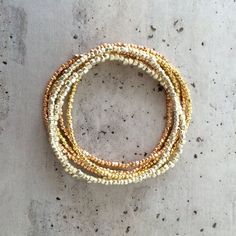 These bestselling bracelets look gorgeous in a single colour, or really stunning stacked with the silver, gold and rose gold version.   Normal price for 4=32, so save £6 on this 4-bracelet deal!Permanent gold finish Japanese glass seed beads.  I have tested these beads vigorously, building sandcastles on the beach.  The finish does not wear off!As with all items, thiese bracelets are delivered in a luxurious gift box finished with grosgrain ribbon. If you are ordering a gift, please leave a note Luxury Single Strand Beaded Bracelets, Luxury Single Strand Brown Necklace, Stretch Beaded Bracelets Diy, Bracelets Stack, Beads Craft Jewelry, Circle Earrings Studs, Moonstone Bracelet, Circle Studs, Bead Bracelets