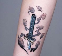 a tattoo on the arm of a person with a knife in it's center