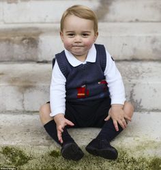 a little boy that is standing up in front of some stairs