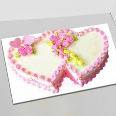 a heart shaped cake with flowers on it