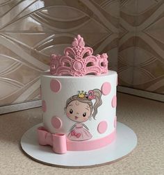 a pink and white cake with a princess on it