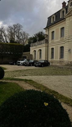 a large house with cars parked in front of it