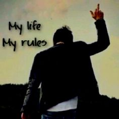 a man is walking with his hand up in the air and saying, my life my rules