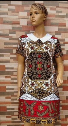 Obasima's African Short dress. it comes with some touches of carefully and beautifully designed embroidery.  It is a hand crafted Afro-chic dashiki. It comes in various sizes which you select from the size chart when placing your order. I accept custom measurements to process your orders for you if you want. So it is a custom made piece for you to show off in.  If you have any questions whatsoever, please feel free to contact me and i will gladly help. I am at your service. Dashiki Outfit, Ankara Dress Styles, Short African Dresses, African Fashion Skirts, African Dresses Modern, Ankara Gown Styles, African Wear Dresses, Afrikaanse Mode, African Fashion Ankara