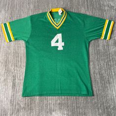 Vintage 80s Green Bay Packers NFL Football Brett Farve Sportswear Athletic 1980s Fashion Green Graphic T Shirt Medium Mens Condition:  Excellent Used Condition  = No Flaws Measurements: Please see photos above for all measurements IF YOU BUY TWO OR MORE ITEMS USE THE CODE BUNDLE @ CHECK TO SAVE 20% WE SHIP WITHIN 24 HOURS AFTER PURCHASE! Please be aware that we do not offer free returns!! The Buyer is responsible for the cost of the return label.  Follow us on TikTok & Instagram @findsnostalgic Green Cotton Sporty Jersey, Retro Green Sports Top, Retro Green Tops For Sports, Throwback Green Tops For College, Retro Green T-shirt For Sports, Green Crew Neck Retro Top, Retro Crew Neck Tops For Sports Season, Throwback Green Tops For Sports Events, 90s Green Sports Tops