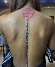 the back of a woman's neck with flowers on it