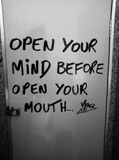 an open door with graffiti written on it and the words open your mind before open your mouth