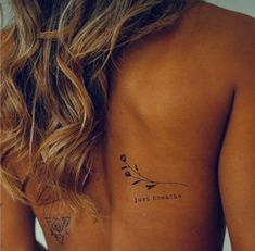 a woman with a tattoo on her back