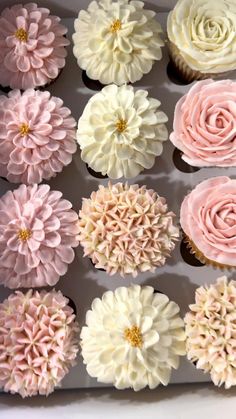 cupcakes with pink and white frosting in a box