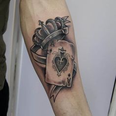 a man's arm with a tattoo on it and a playing card in the middle