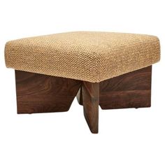 the foot stool is made out of wood and has a woven seat pad on it