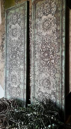 two doors with intricate designs on them in a room