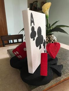 a table topped with cards and flowers on top of it