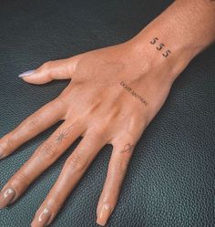 a woman's hand with tattoos on it and the word love written in cursive writing