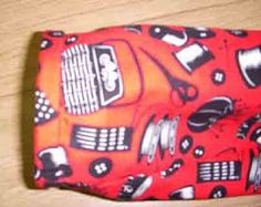 an orange and black cell phone case with cars on it sitting on a wooden surface