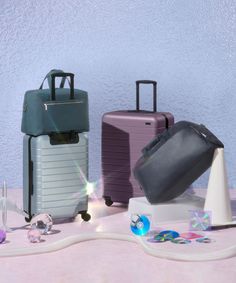 several pieces of luggage sitting on top of a table next to other items and objects