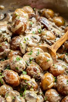 cooked mushrooms with gravy and parsley in a skillet, ready to be eaten