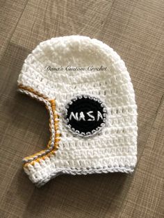 a crocheted hat with the nasa logo on it